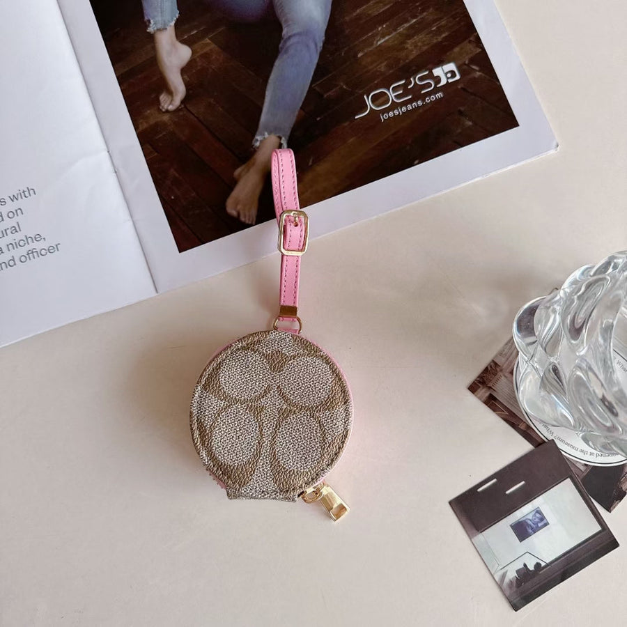 Coach-inspired round monogram AirPods case with wrist strap