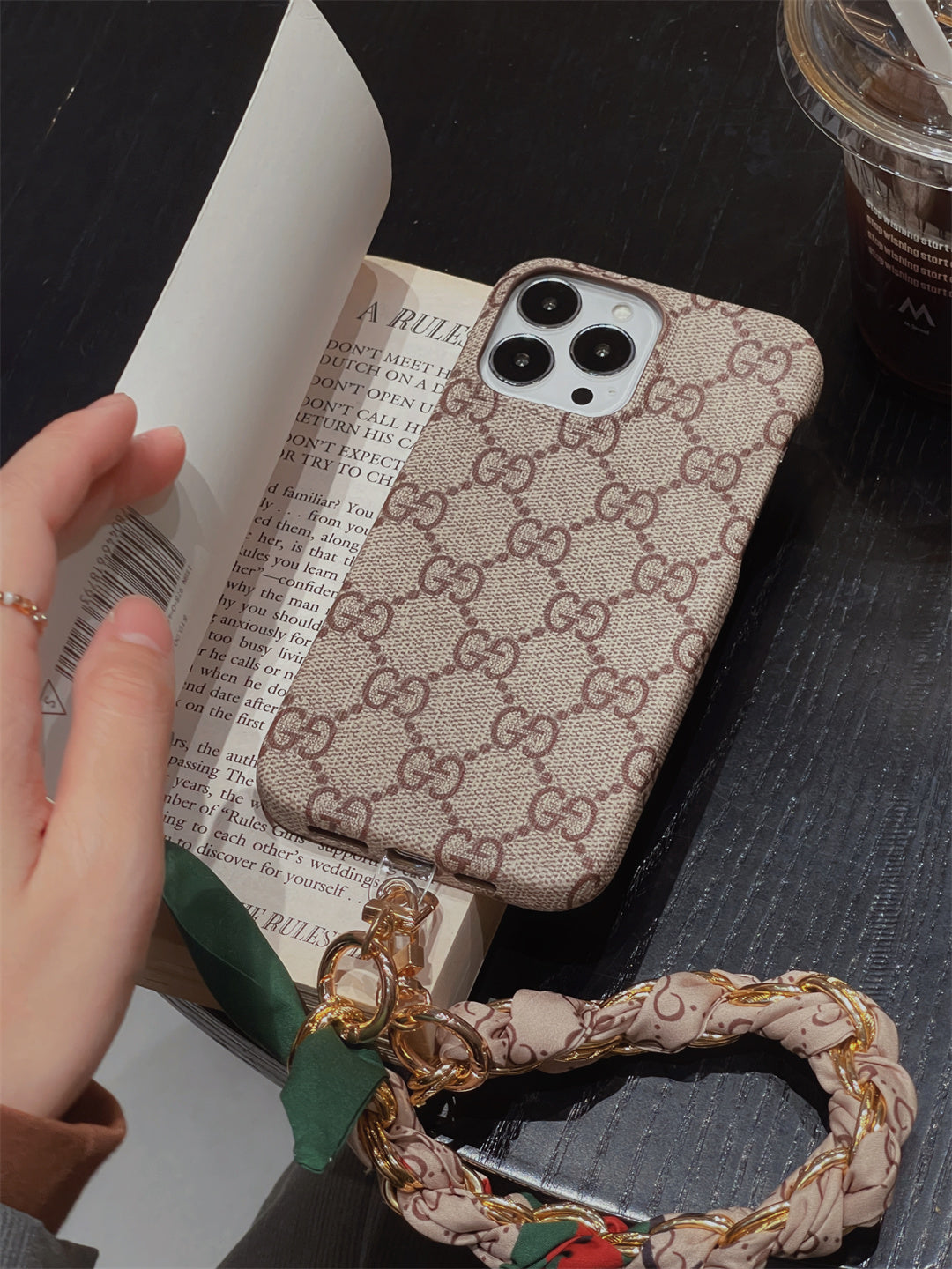 Louis Vuitton-inspired phone case with hand strap