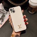 Louis Vuitton-inspired textured iPhone case with gold-tone emblem