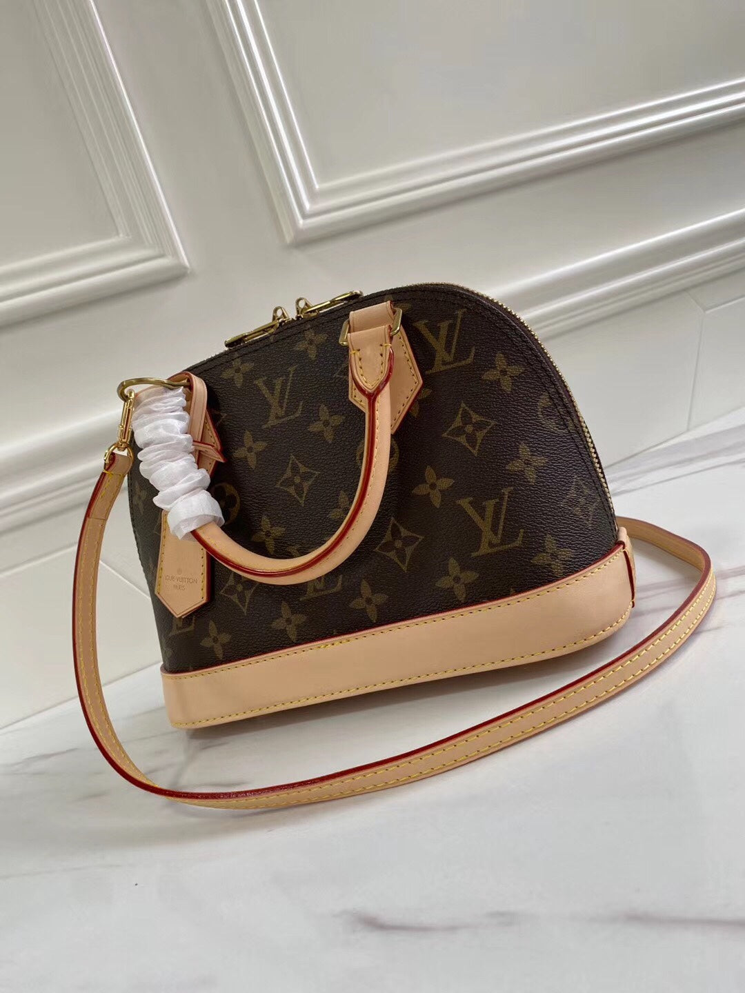 Louis Vuitton-inspired dome-shaped monogram handbag