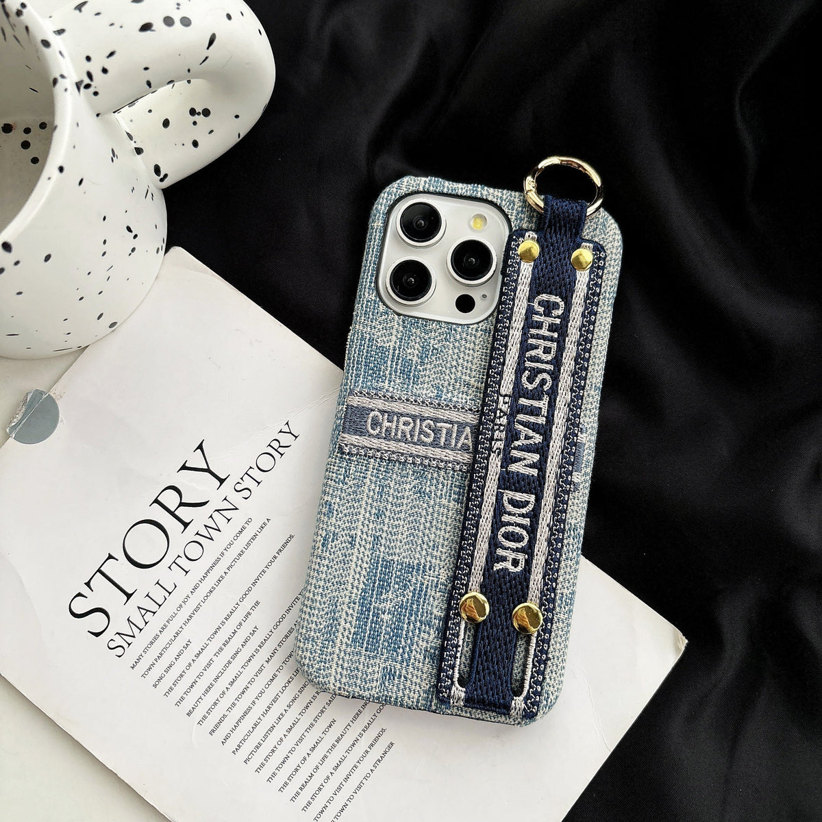 Dior-inspired patterned phone case with wide hand strap