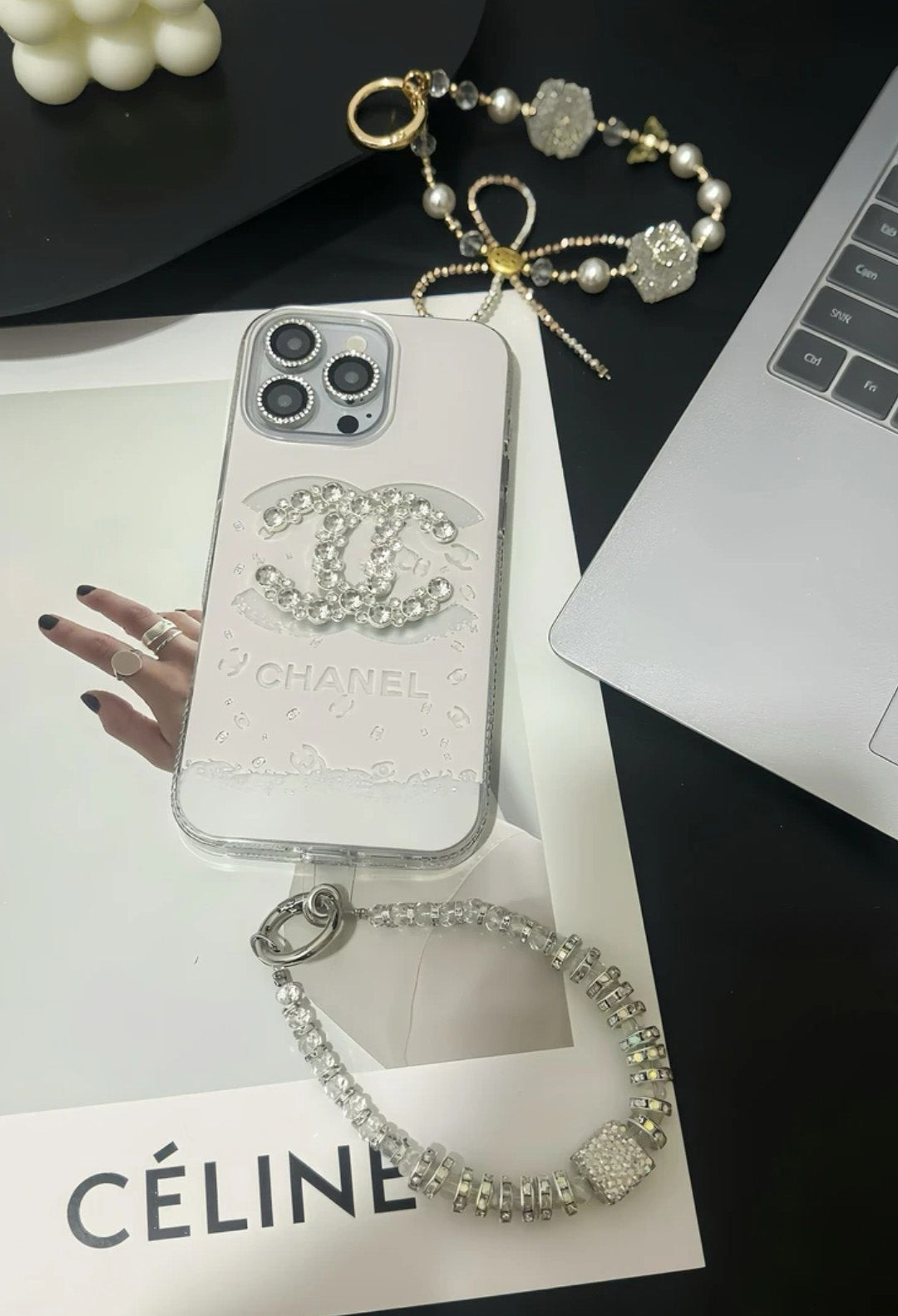 Chanel-inspired light iPhone case with rhinestone emblem