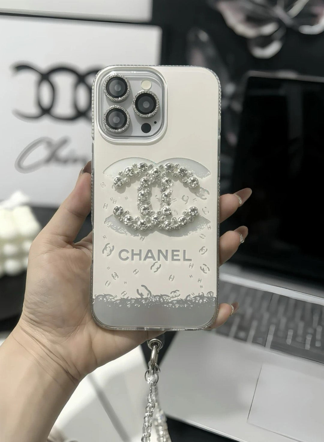 Chanel-inspired light iPhone case with rhinestone emblem