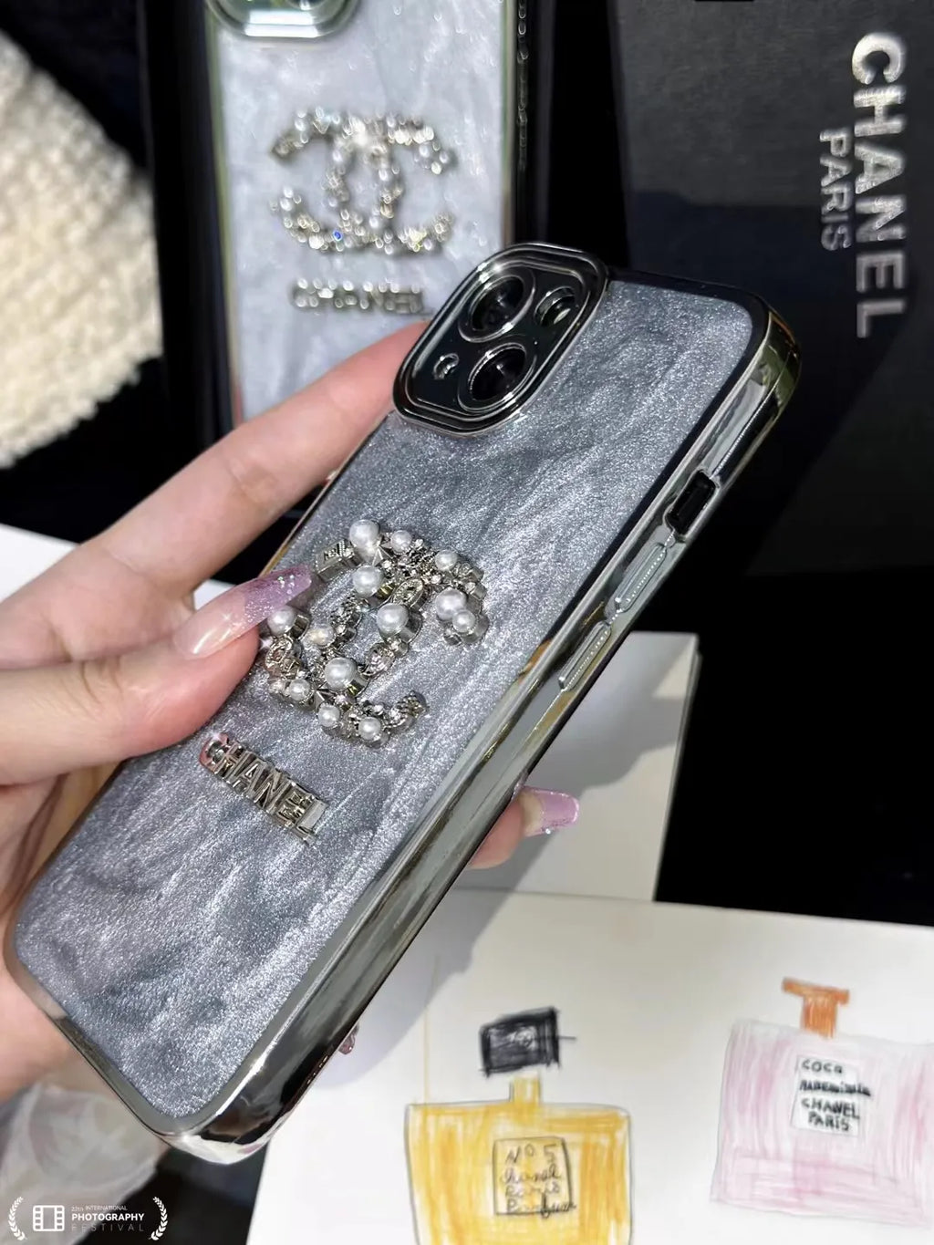 Chanel-inspired glitter case for iPhone 15 Pro Max with chain detail