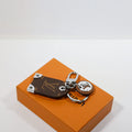 Louis Vuitton-inspired monogram leather keyring with charm, brown