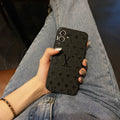 Louis Vuitton-inspired black embossed monogram iPhone 17 case