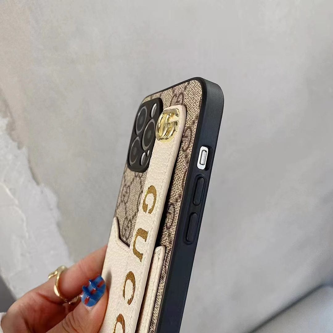 Gucci-inspired monogram phone case with studded hand strap