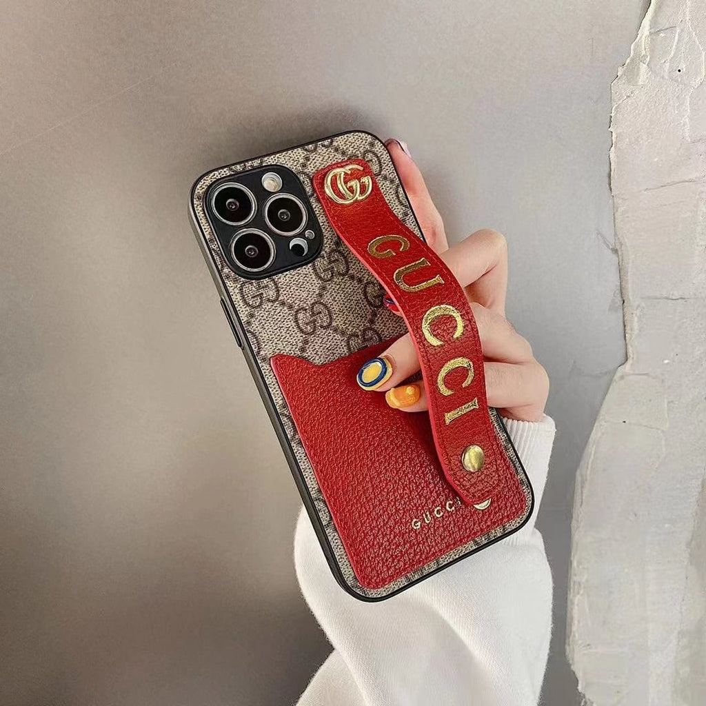 Gucci-inspired monogram phone case with studded hand strap