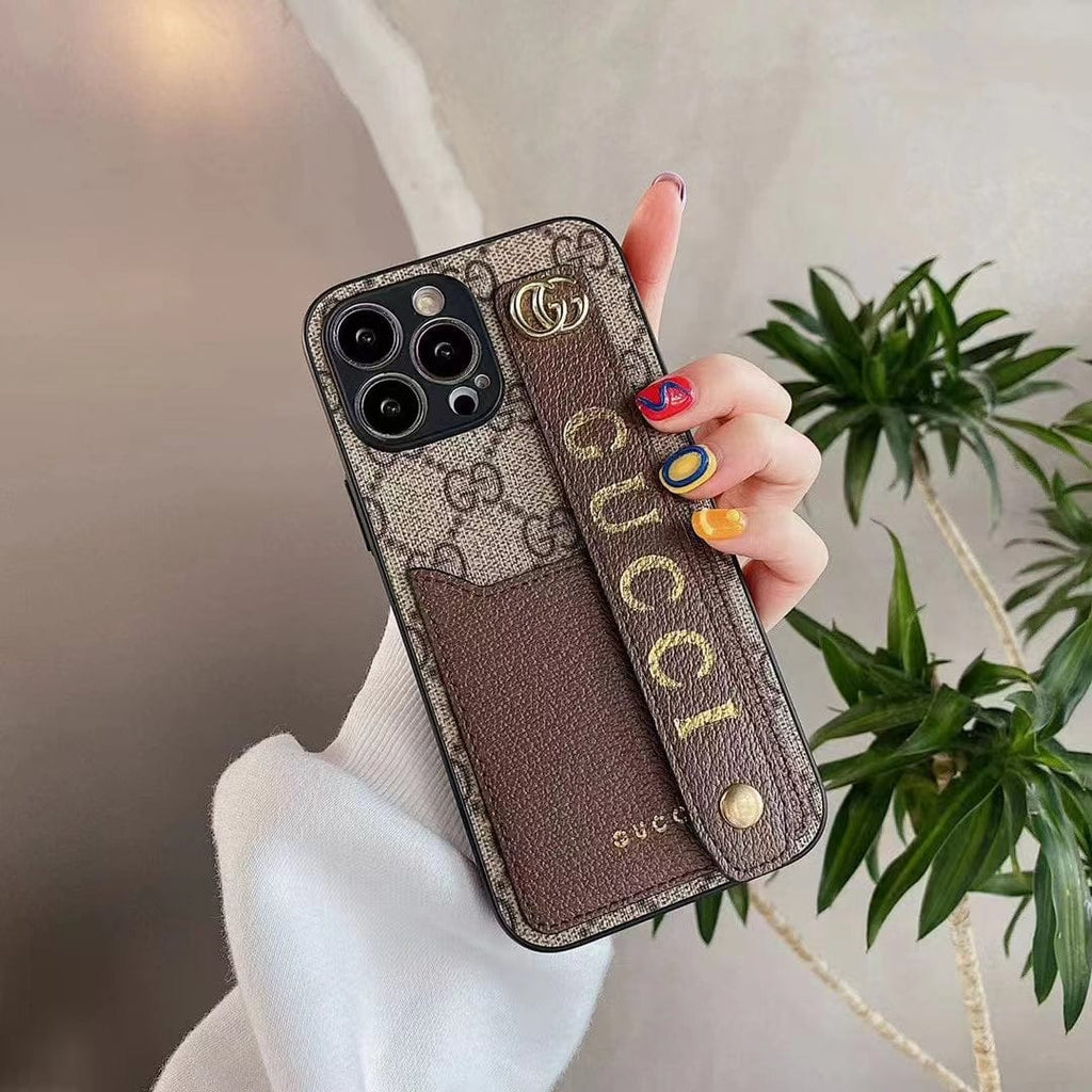 Gucci-inspired monogram phone case with studded hand strap