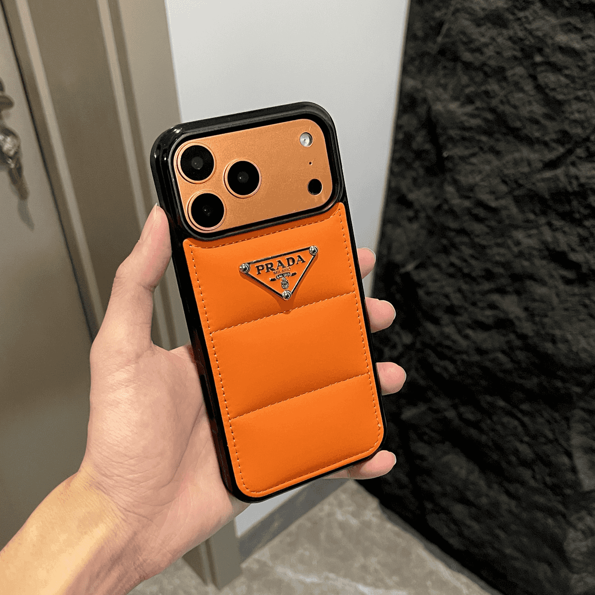 Prada-inspired puffer iPhone case with triangle detail
