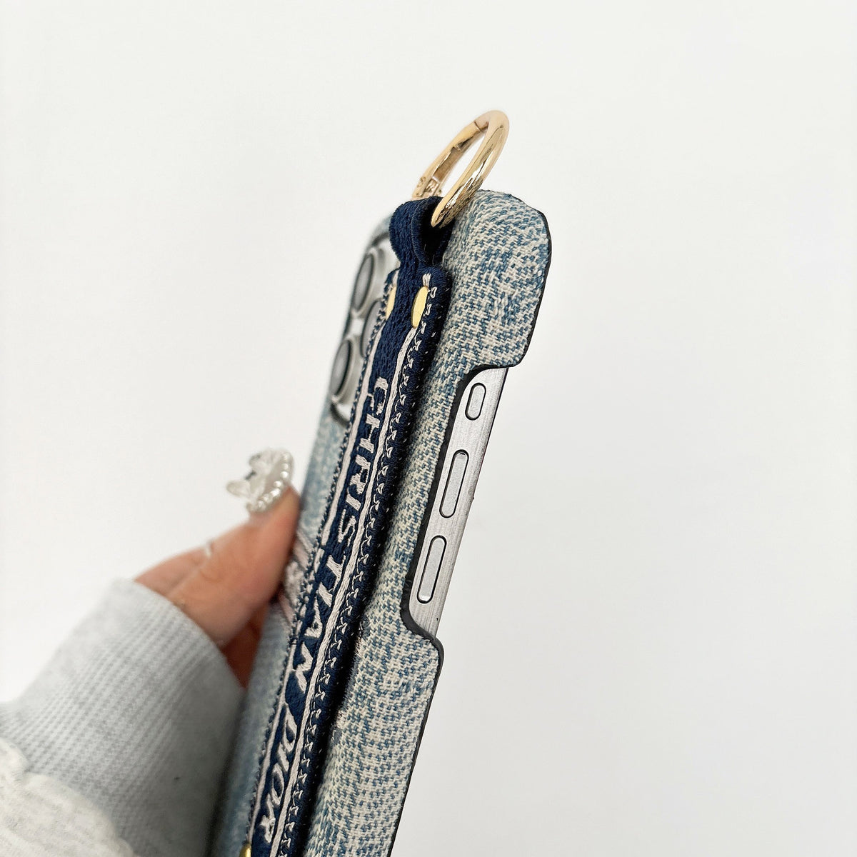 Dior-inspired patterned phone case with wide hand strap