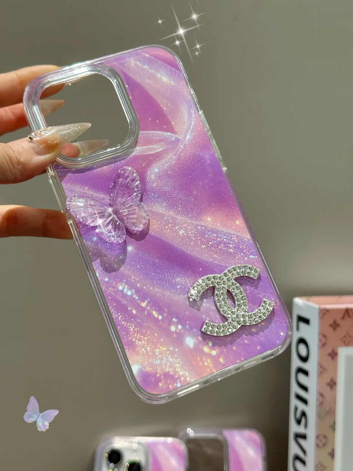 Louis Vuitton-inspired marbled phone case with chain charm