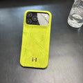 Hermes-inspired solid color iPhone 17 case with metal initial detail
