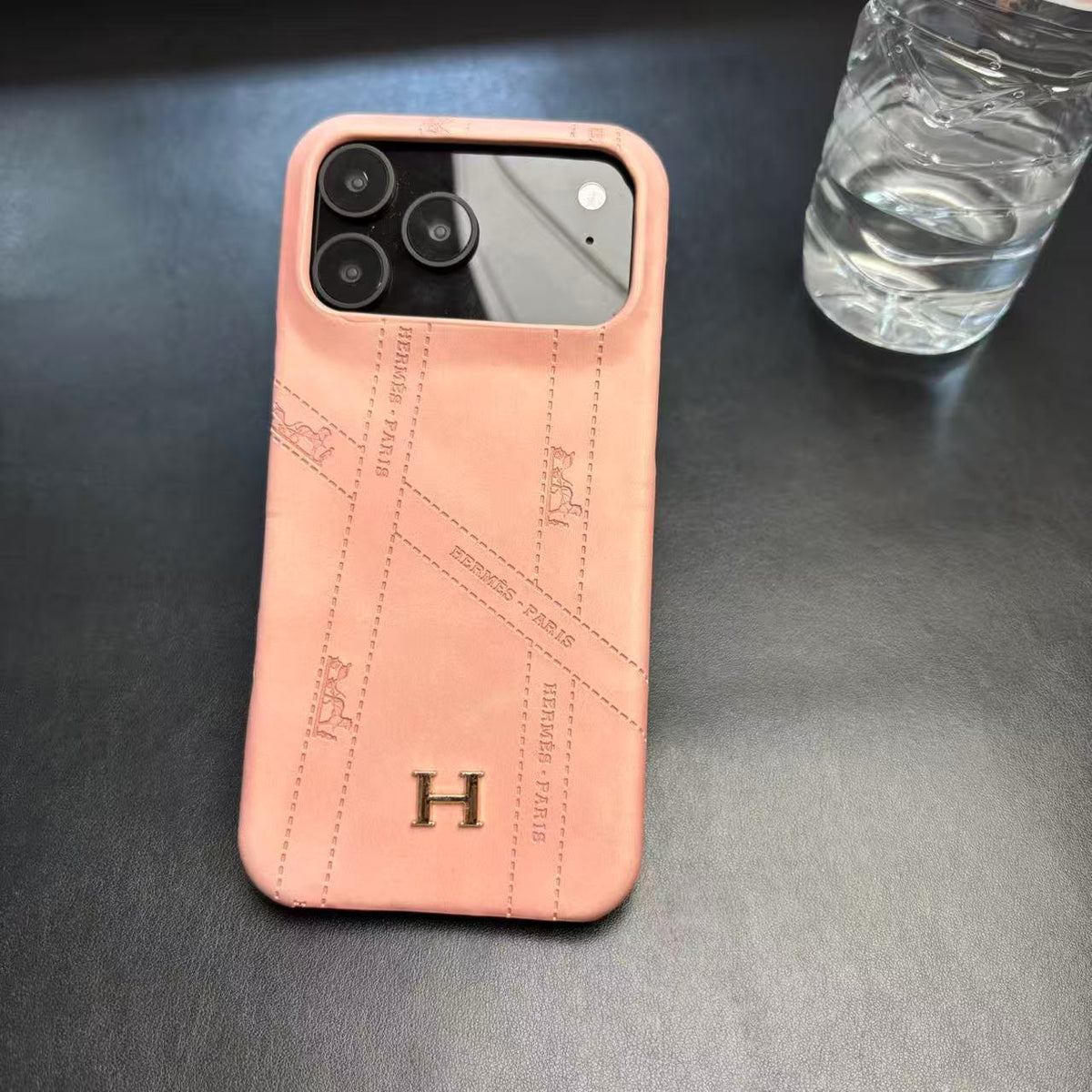 Hermes-inspired solid color iPhone 17 case with metal initial detail