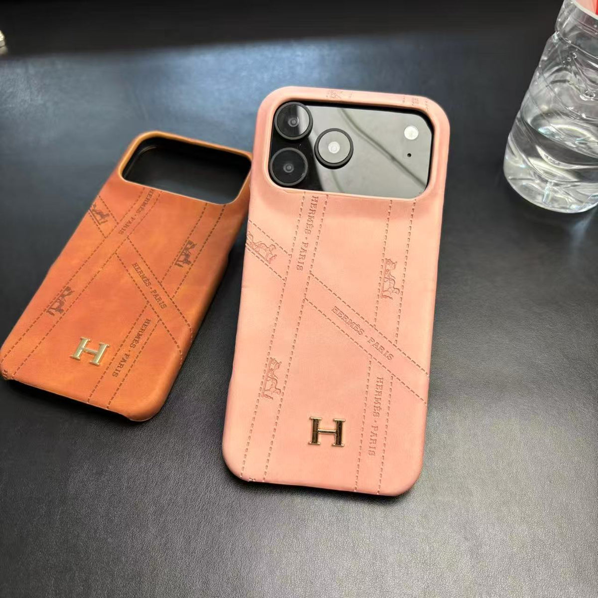 Hermes-inspired solid color iPhone 17 case with metal initial detail