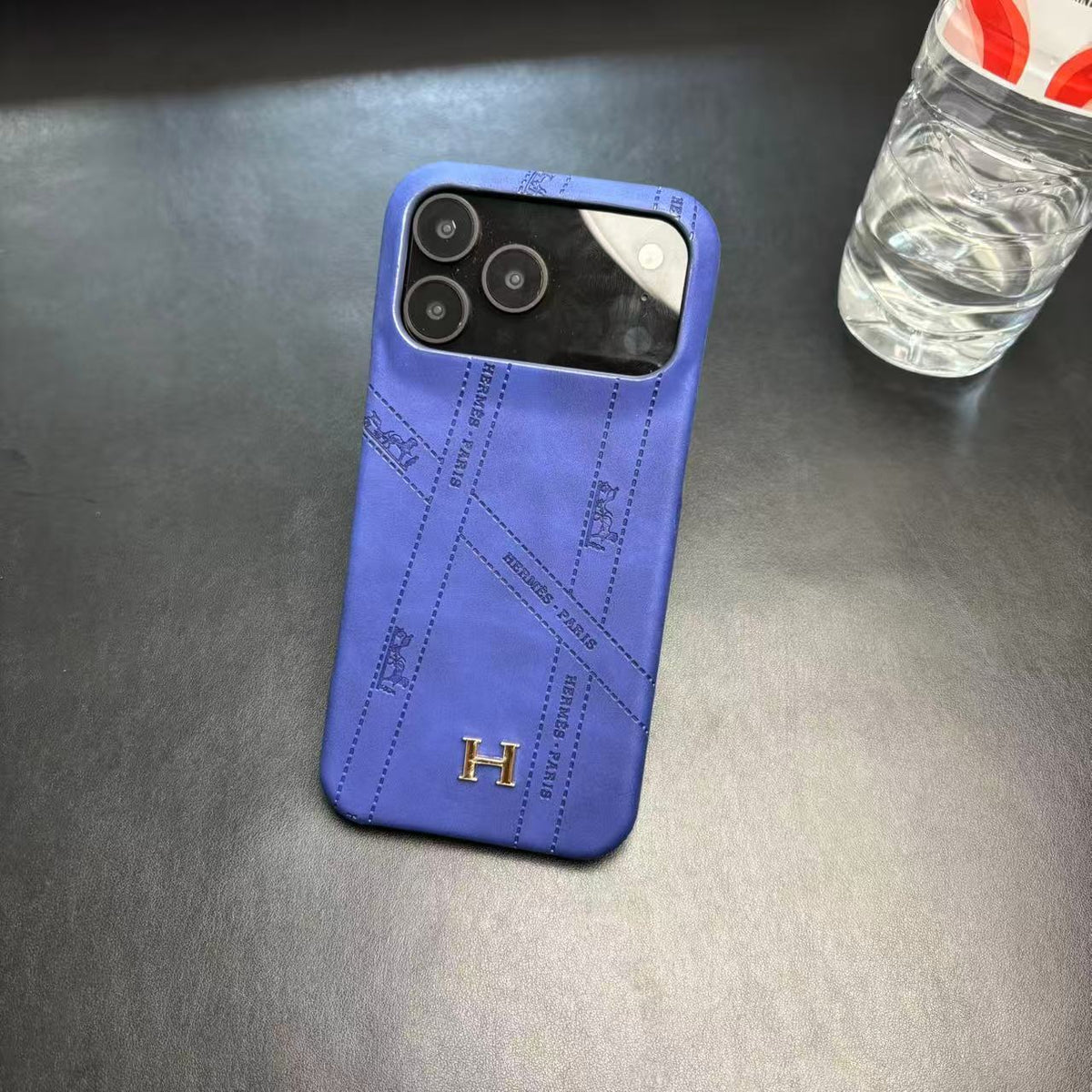 Hermes-inspired solid color iPhone 17 case with metal initial detail