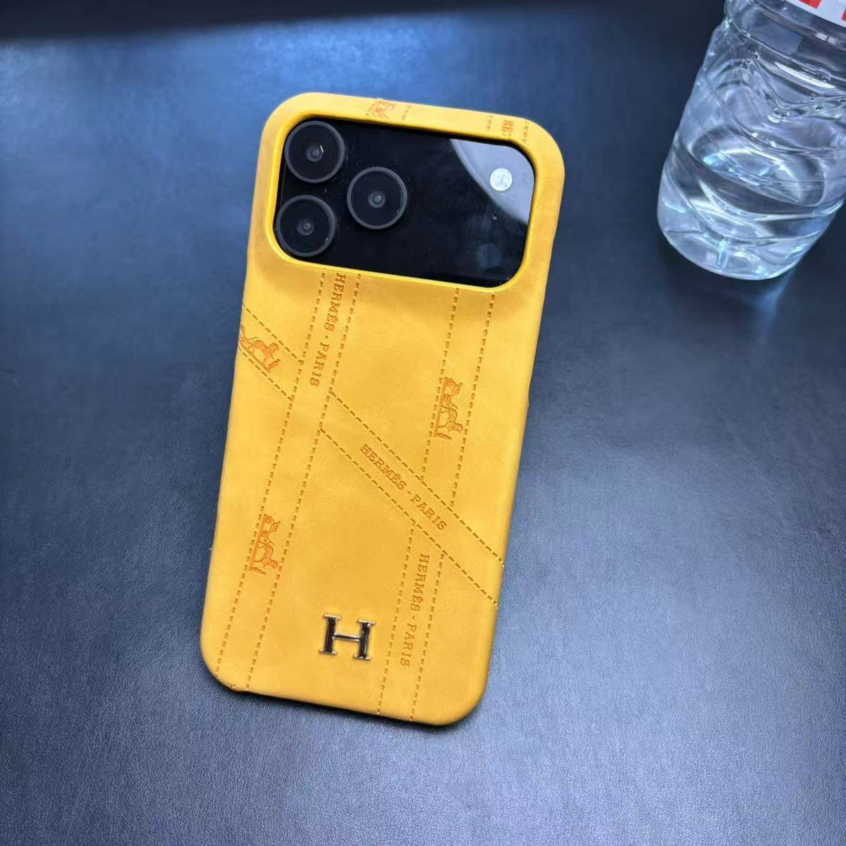 Hermes-inspired solid color iPhone 17 case with metal initial detail