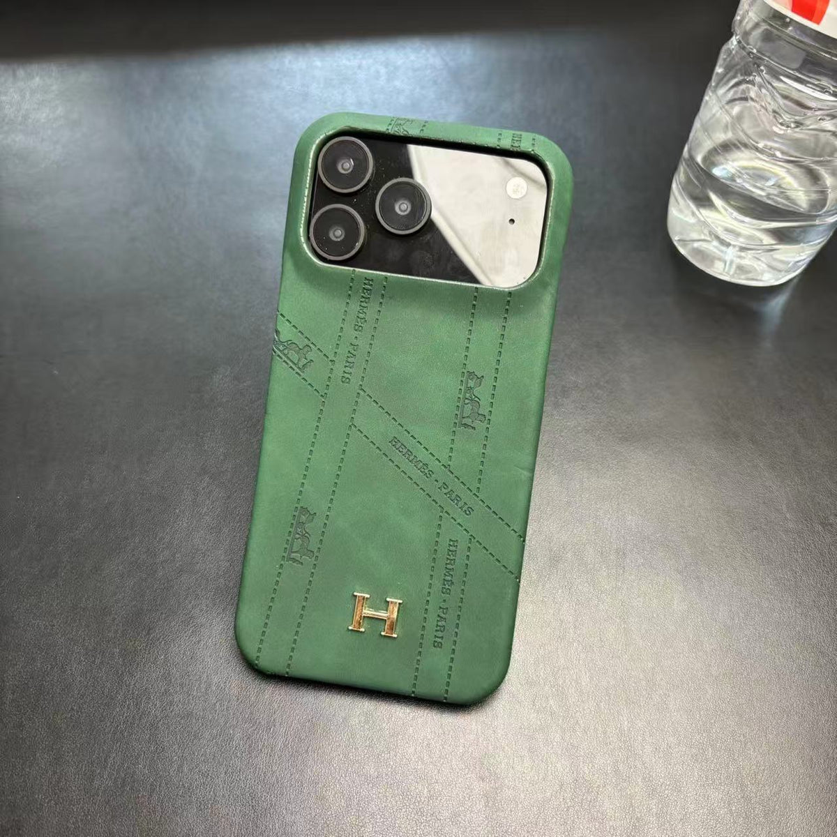 Hermes-inspired solid color iPhone 17 case with metal initial detail