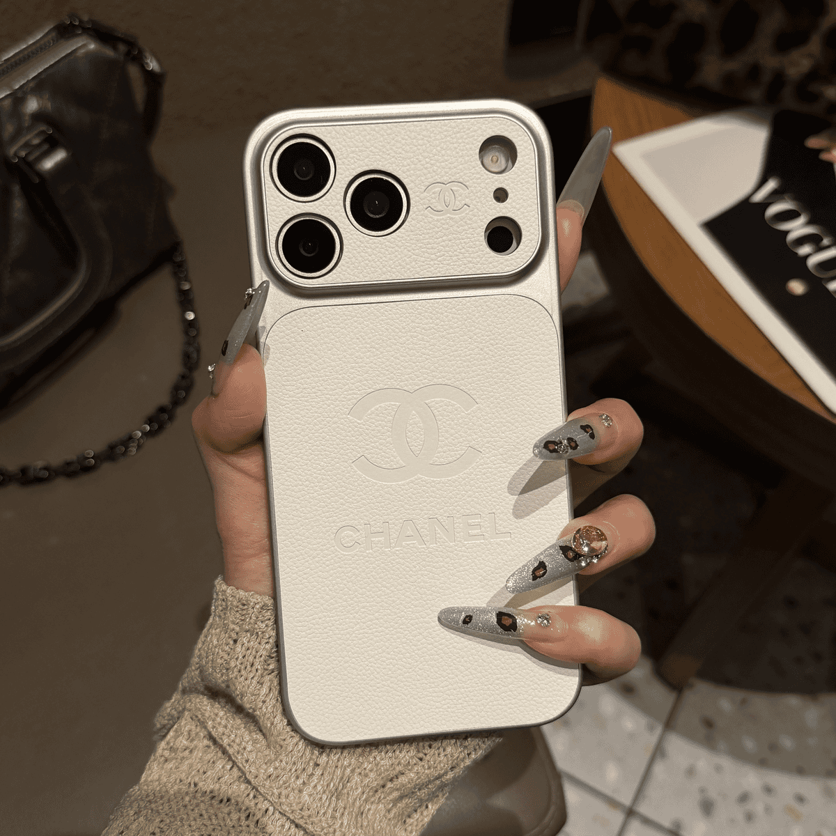 Chanel-inspired solid color iPhone case with embossed emblem