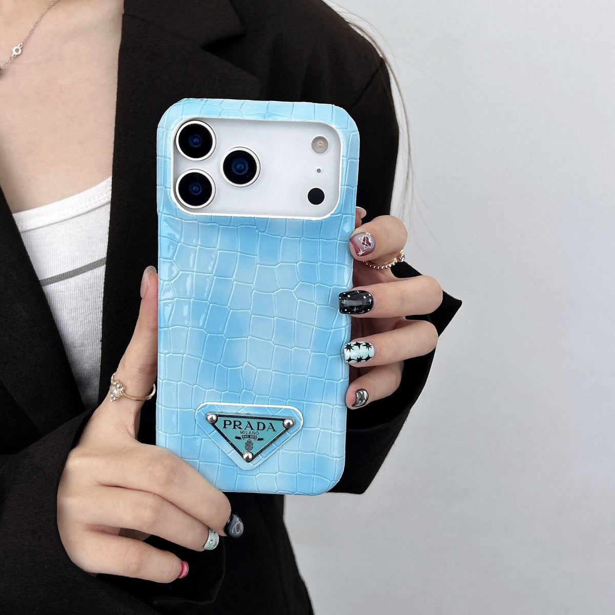 Prada-inspired pastel textured iPhone 17 case with triangle detail